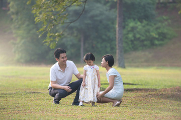 Happy Asian Family enjoying family time together in the park