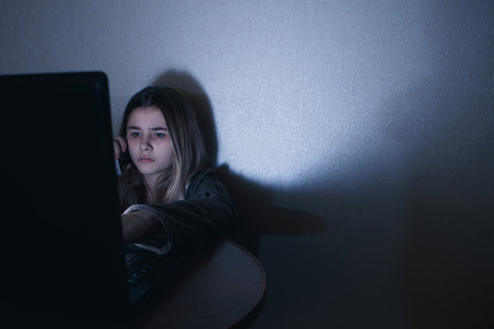 Teen girl excessively sitting at the phone at home. he is a victim of online bullying Stalker social networks
