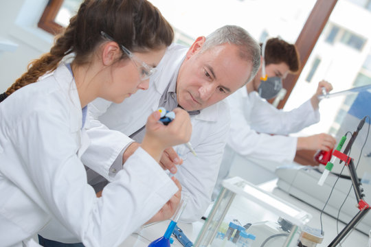 young woman apprentice testing in a lab