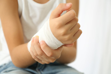 Close up view of little boy's wrist with applied bandage