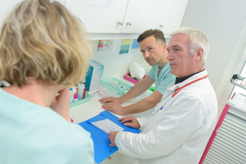doctor discussing results with nurse team