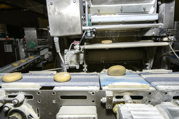 Bread dough running on conveyor belt