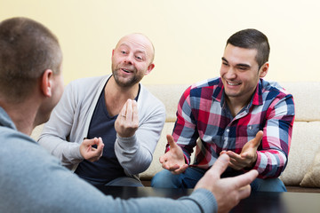 Obraz premium Adult guys sitting at table