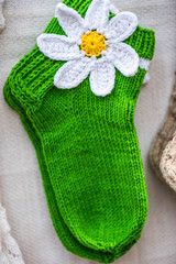 Handmade green wool socks with the white flower