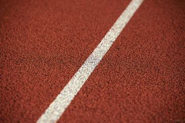 Athletics stadium running track white lines marks.

