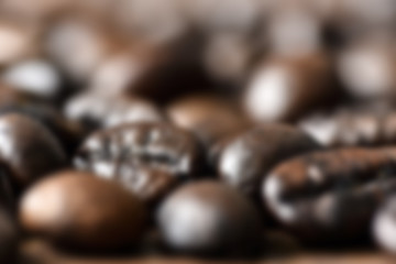 Roasted coffee beans on board close-up - blured