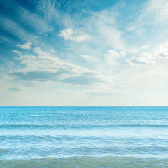 Fototapeta premium dark sky with clouds over blue sea in sunset