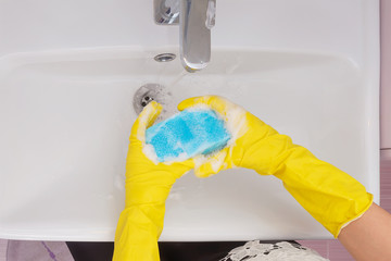 Close up view on hand covered with yellow glove