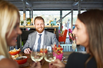 business people meeting in modern restaurant, colleagues having dinner and take drink after work