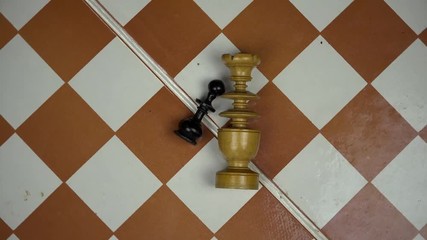 wooden chess figures lying on chess board. turntable anticlockwise