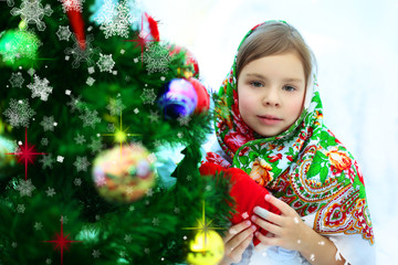 Portrait of adorable little girl near new year tree