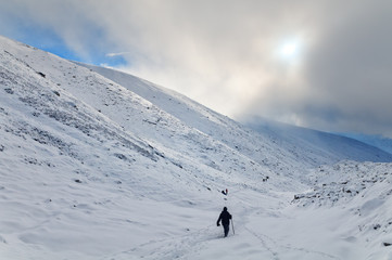 Сlimber on the pass and approaching blizzard.