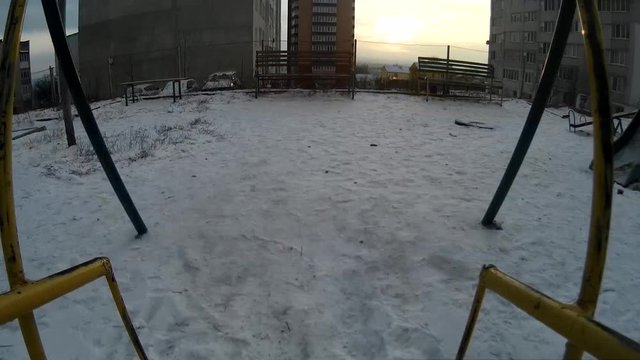 Empty swing set POV action camera fottage Ukraine, Khmelnytskyi