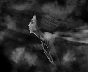woman with closed eyes flyng in night clouds, monochrome image