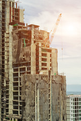 Fototapeta na wymiar Building and cranes under construction.