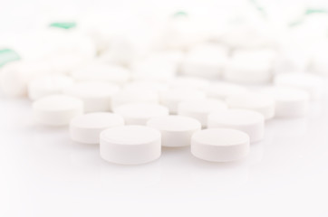 Closeup. Pharmacy theme. White Pills on the White Surface