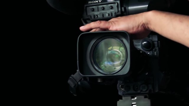 Close - up lens of black camera - man works with camera