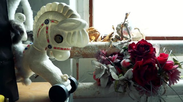 Small white children's horse and bouquet of rose