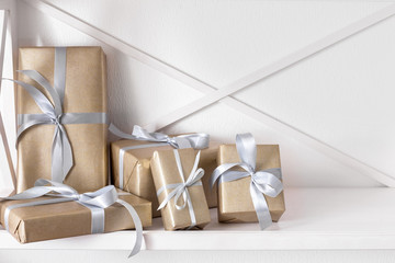 Elegant presents, gift boxes on white shelves background, closeup