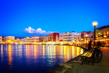 Fototapeta premium illuminated venetian bay of Chania at night, Crete, Greece, retro toned
