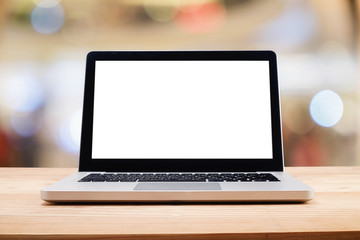 Fototapeta premium Computer with white screen on table with blur background. Technology concept..