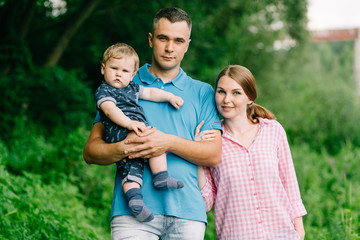Fototapeta premium family with baby on the nature in the summer near the river