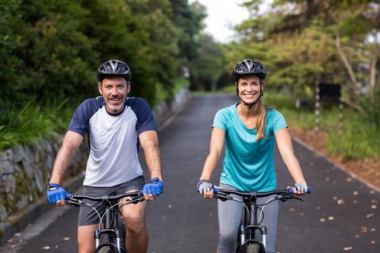 Athletic couple cycling on the open road