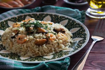 Seafood risotto on a green plate