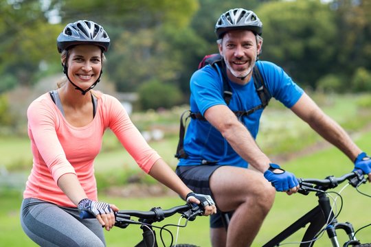 Athletic Couple Cycling On The Road