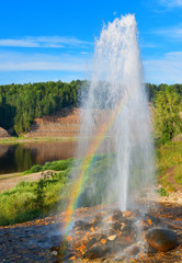 Naklejka premium Rainbow in geyser splashes on the Sukhona River in Russia.
