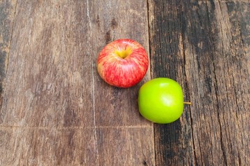 red and green apple on wooden background, top view 