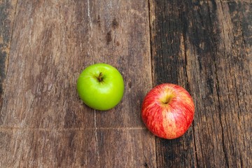red and green apple on wooden background, top view 