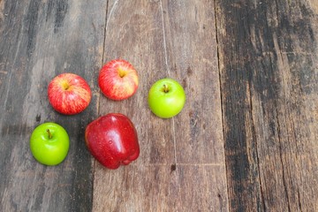 red and green apple on wooden background, top view 