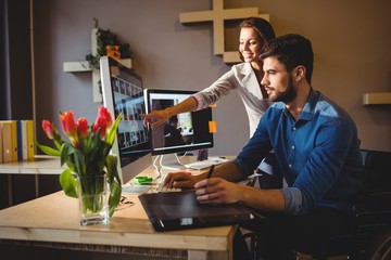 Woman showing her colleague something on the screen