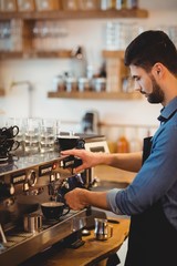 Man taking coffee from espresso machine