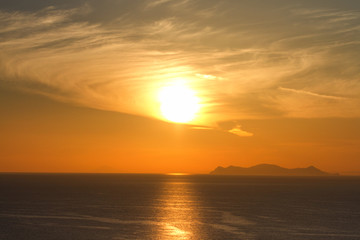 Fototapeta na wymiar Sunset in Oia, Santorini. Volcano caldera on background. Horizon