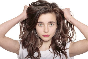 portrait of a teenage girl who is pulling her hair out