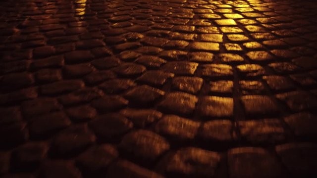 Ancient urban pavement close up 4K steadicam night shot