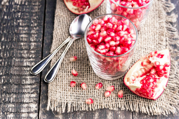 Fresh organic pomegranate seeds in glasses