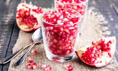 Fresh organic pomegranate seeds in glasses