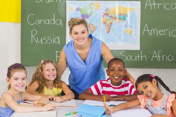Portrait of teacher and kids in classroom