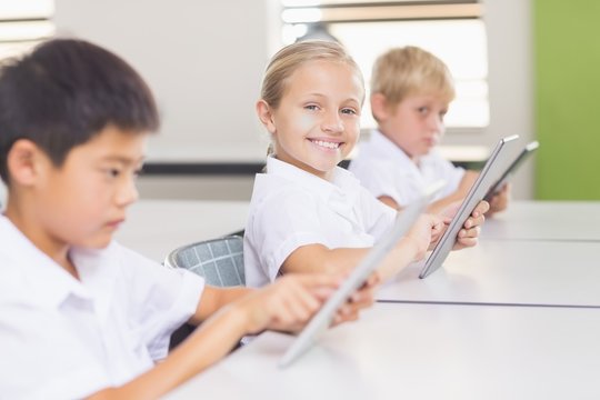 Kids using digital tablet in classroom