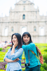 Asian tourist women take photo in front of St.Paul Church in mac