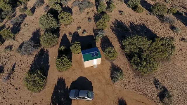 Aerial view of a tiny house on a large lot