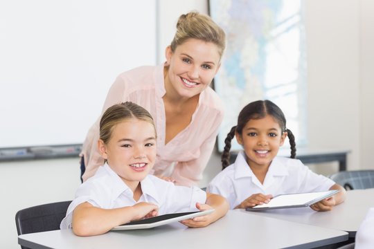 Teacher and kids using digital tablet