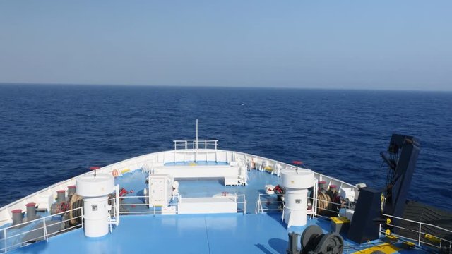 Bow of great blue and white ship on ocean.