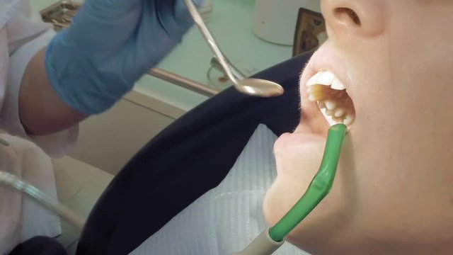 Woman at the dentist clinic office gets dental medical examination and treatment. Close up shot. Odontic and mouth health is important part of modern human life that dentistry help with.