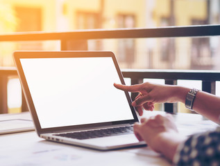 Modern business with white screen laptop and some paper with chart, graph and report,morning light in coffee shop