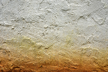 Rough white wall cement texture.Cement stucco wall with randomly plastered finishing. The yellow stain at the bottom effected by rainfall on ground.