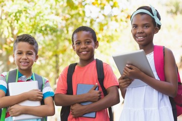 Portrait of school kids using digital tablet